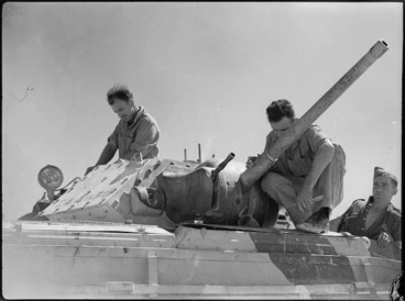 Image: Men working on a Crusader tank at 4th Armoured Brigade workshops in Maadi, Egypt - Photograph taken by George Kaye
