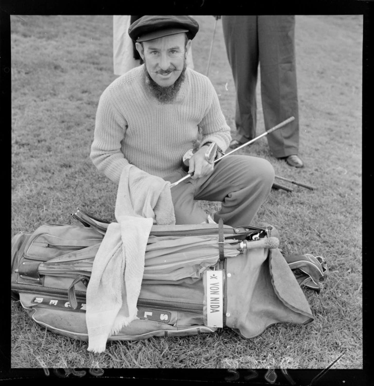 Image: Unidentified man [X Von Nida?] polishing his golf clubs, Paraparaumu Golf Club, Kapiti Coast District, Wellington Region, including golf bag and waxed moustache