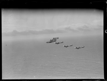 Image: Group of Curtiss P-40 Kittyhawk aircraft flying in formation over ocean