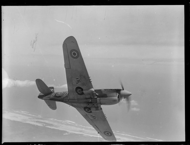 Image: A Curtiss P-40 Kittyhawk aircraft in flight