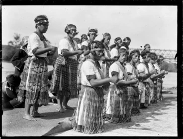 Image: Unidentified Maori women dancing, includes traditional dress (piupu), head bands with taniko design and poi