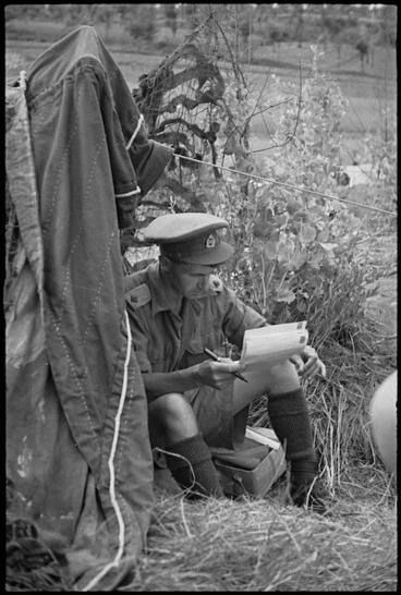 Image: Lieutenant A R Martin censoring mail outside his bivy near Sora, Italy, World War II - Photograph taken by George Kaye