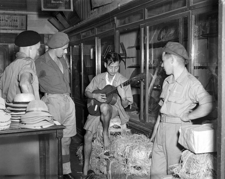 Image: New Zealanders of J Force listening to a Japanese music-seller on guitar, Yamaguchi, Japan