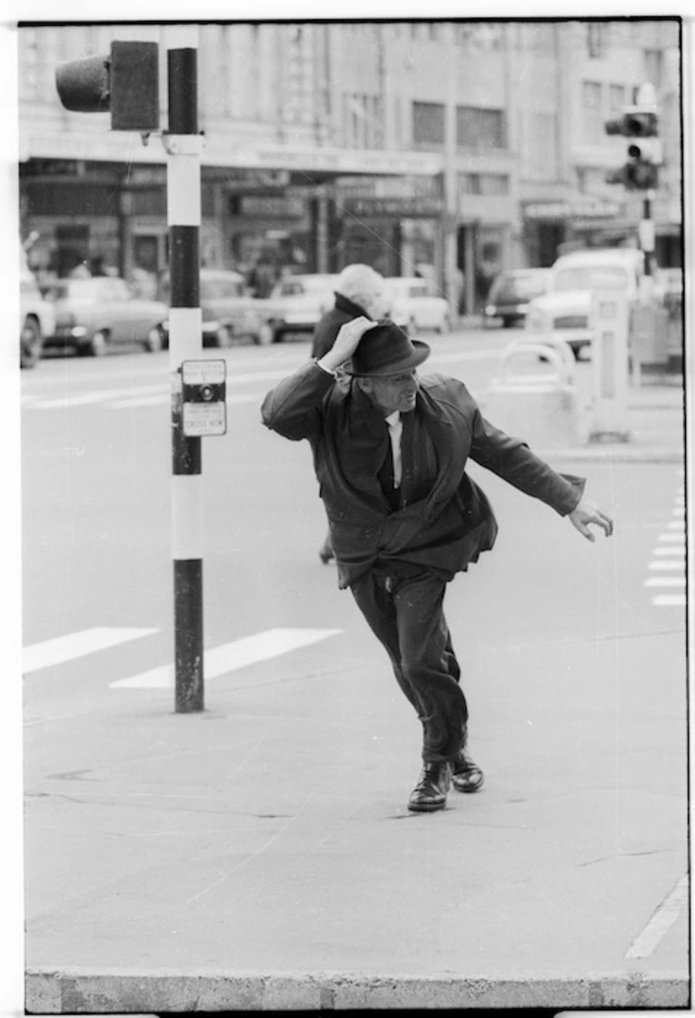 Image: Man walking against strong wind, Wellington