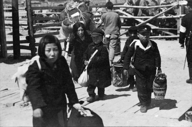 Image: Korean children carrying their belongings