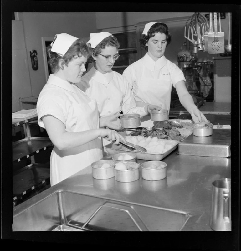 Image: Female staff members, all unidentified, in kitchen at Wellington Hospital, preparing food for 'Meals on Wheels' service