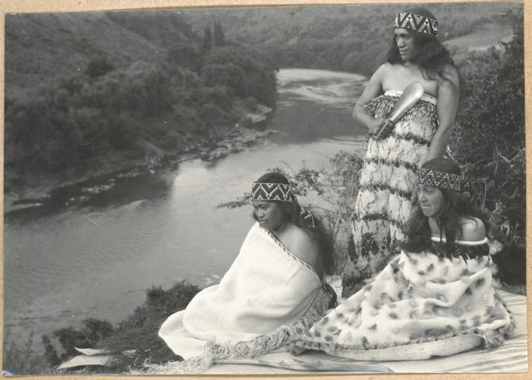 Image: Three women wearing cloaks and headbands