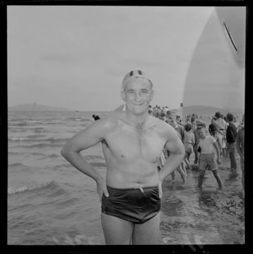 Image: An unidentified man who just completed the Somes Island Petone swim on Petone Beach with children looking on, Wellington City