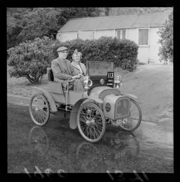 Image: Mr & Mrs E W Delaney driving a 1902 Crestmobile on an unknown street, probably Wellington Region