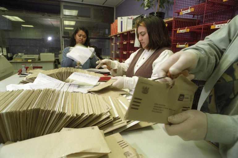 Image: Social Welfare staff open copies of the social responsibility code questionaire - Photograph taken by Craig Simcox.