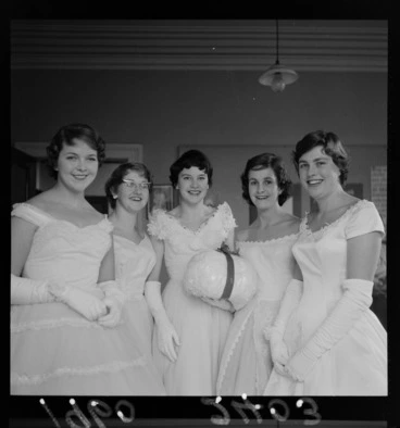 Image: Group portrait of debutante girls in evening dresses with lucky snowball for the Plunket Ball, probably Wellington Region