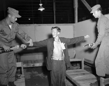 Image: Prisoner of war Graeme Garland being treated with anti-lice spray on return from captivity, Korea