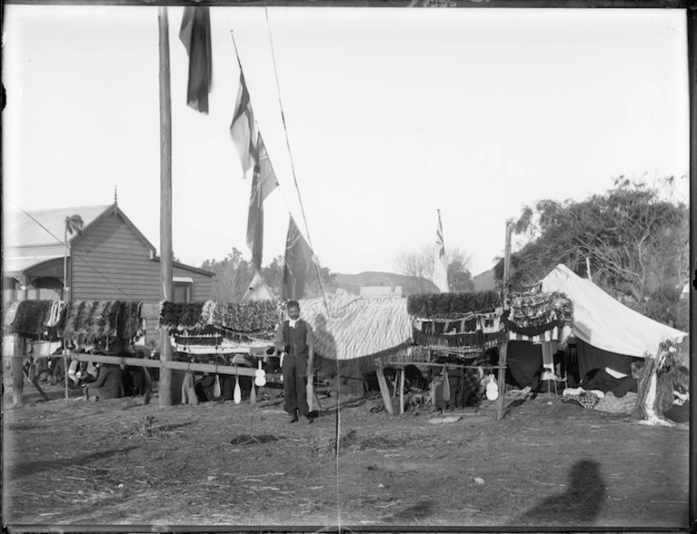 Image: Display of cloaks and patu at a tangi