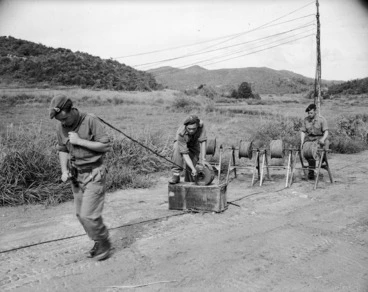 Image: Men from Charlie troop, Royal NZ Signals Regt, laying telephone cable in Korea