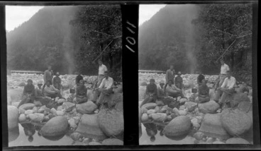 Image: Group of men and women sitting beside a small campfire on a rocky river bed, including Edgar and Alice Williams (at the back), unknown location
