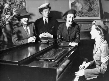 Image: Unidentified group of women wearing World War II military uniforms, around a piano