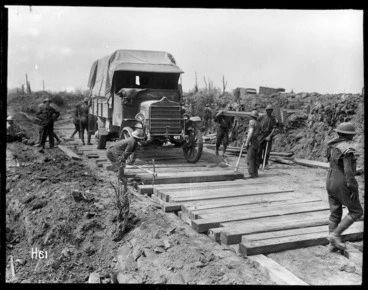 Image: Members of the Pioneer Battalion laying a road in Messines, Belgium