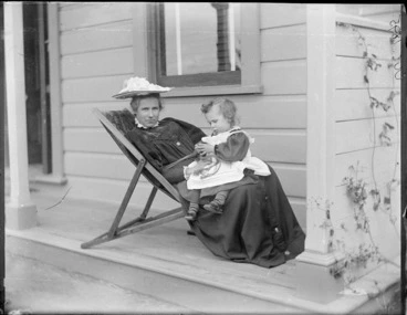 Image: Lydia Williams, with a child, possibly her son Owen William Williams, sitting on her porch, Royal Terrace, Kew, Dunedin