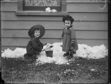 Image: Edgar Williams with unidentified child playing in snow at the Williams' home, Kew, Dunedin