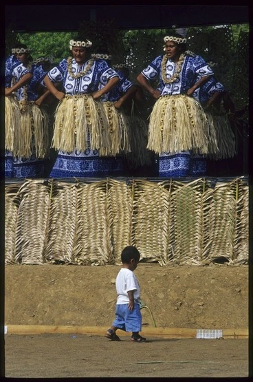 Image: Little boy walking in front of Tokelau performers at the 8th Festival of Pacific Arts, Noumea, New Caledonia