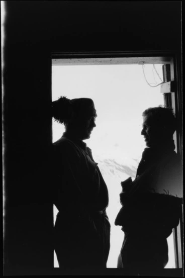Image: Interior of Ball Hut, with two unidentified men in doorway looking out to mountains, Mount Cook National Park, Canterbury Region