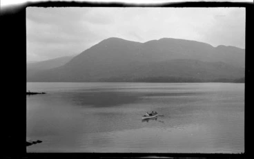 Image: Lake scene, including people in row boat on lake with mountain in background, Killarney, County Kerry, Ireland