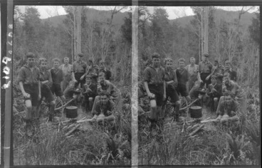 Image: Edgar Williams (centre, back), with group of schoolboys, boiling a billy over campfire in native forest, probably West Coast Region