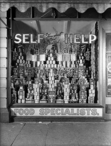 Image: Display of groceries in a shop front window(probably the Wellington branch of Self Help Co-op Grocery Ltd at 296 Willis Street))