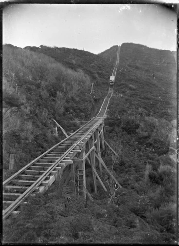 Image: View of the top of the Karekare Incline, with a load of sawn timbers descending to Karekare.