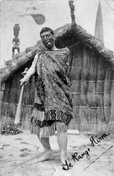 Image: Peter Henry Buck wearing traditional Maori clothing, wielding a wooden weapon