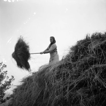 Image: Woman stacking linen flax in Geraldine