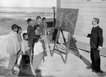 Image: Teacher, outside with a blackboard, taking a geography class