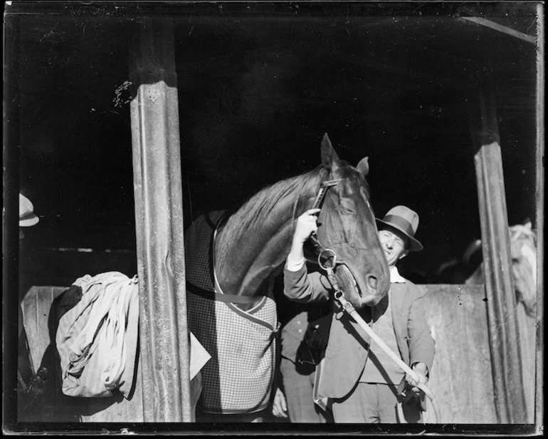 Image: Racehorse Phar Lap, with handler/jockey Reginald James Mackie, at Hugh Telford's stables, Trentham, Upper Hutt