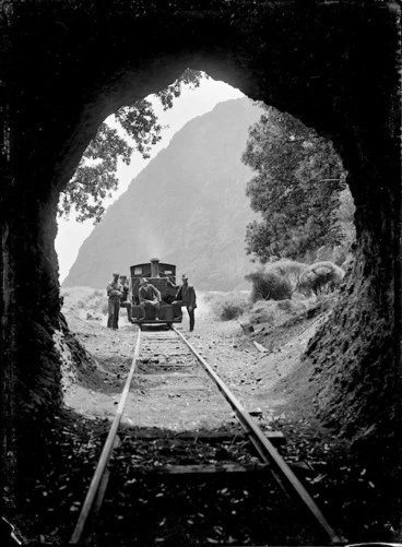 Image: The Piha logging locomotive "Sandfly" framed by the Pararaha Tunnel mouth.