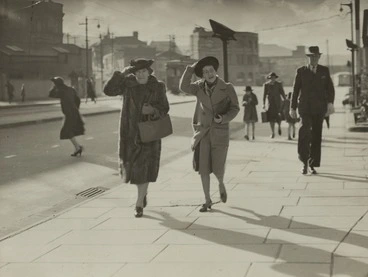 Image: Women holding on to their hats during a windy day, Thorndon Quay, Wellington - Photograph taken by C P S Boyer