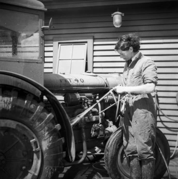Image: A member of the Women's Auxiliary Air Force hosing down a tractor