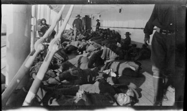 Image: Men of the 9th Battalion lying on the deck of a transport ship taking members of the Australian Imperial Force and the New Zealand Expeditionary Force to Egypt