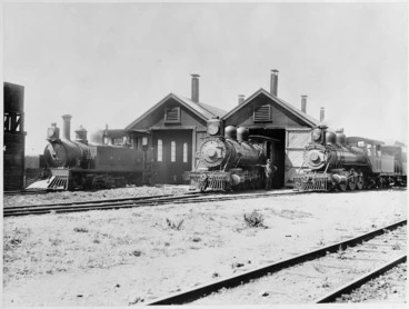 Image: Three Wellington and Manawatu Railway locomotives outside railway sheds