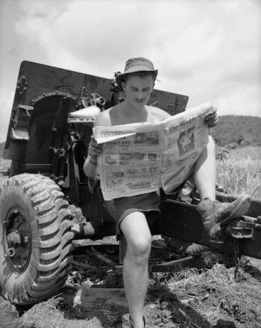 Image: Sgt C Instone reading the Weekly News beside his 25 pdr, Korea