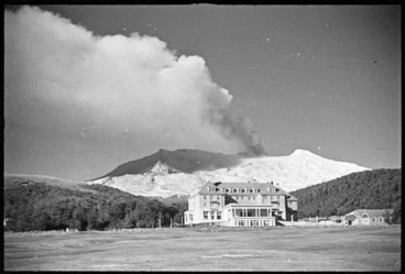 Image: Chateau Tongariro, and Mount Ruapehu erupting behind