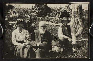 Image: Lady Anna Paterson Stout, Sir Robert Stout, and an unidentified man sitting on a bank