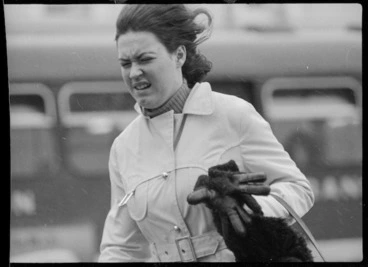 Image: Woman screwing up her face against the wind, Wellington