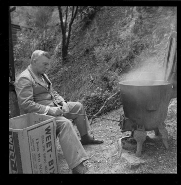 Image: Oliver Duff seated by an outdoor fireplace