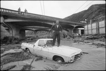 Image: Man surveying flooding under the Petone overbridge, Wellington