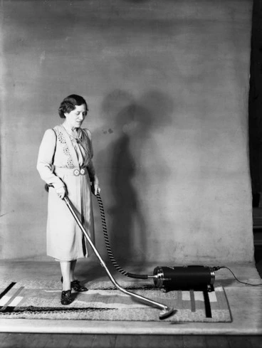 Image: Aunt Daisy (Maud Basham) demonstrating a vacuum cleaner