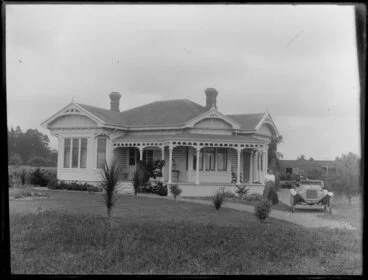 Image: Unidentified couple with motor car in front of a villa, Christchurch