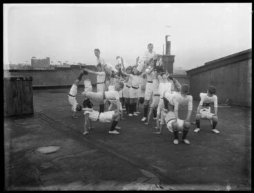Image: A group of boys from a secondary school physical education class doing gymnastics on a rooftop