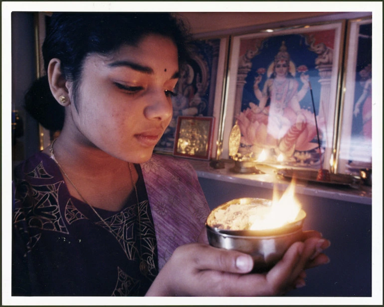 Image: Hindu woman Narmadai Chinniah holding a prayer lamp - Photograph taken by Ross Giblin