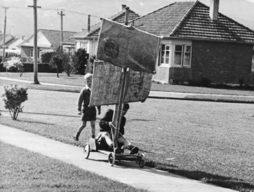 Image: Ian Patrick on a go-cart with sacks for sails, Naenae, Wellington - Photograph taken by C Wilson