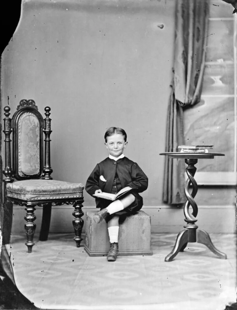 Image: Unidentified boy, posed with a book